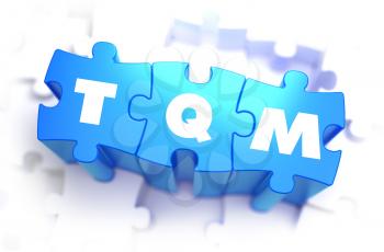 TQM - WWhite Word on Blue Puzzles on White Background. 3D Illustration.