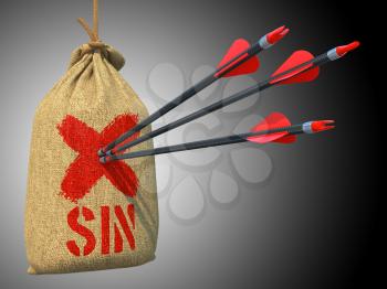 Sin - Three Arrows Hit in Red Target on a Hanging Sack on Grey Background.
