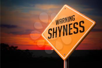 Shyness on Warning Road Sign on Sunset Sky Background.