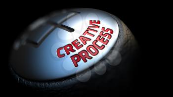 Creative Process - Red Text on Car's Shift Knob on Black Background. Close Up View. Selective Focus.