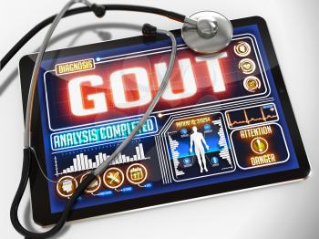 Gout - Diagnosis on the Display of Medical Tablet and a Black Stethoscope on White Background.