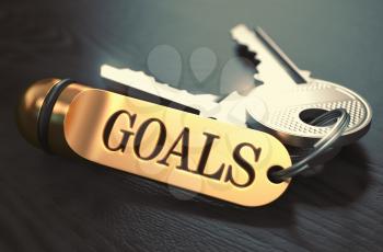 Goals - Bunch of Keys with Text on Golden Keychain. Black Wooden Background. Closeup View with Selective Focus. 3D Illustration. Toned Image.