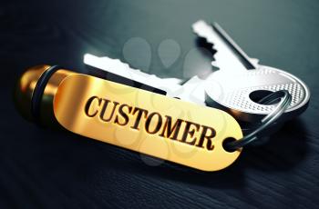 Customers Concept. Keys with Golden Keyring on Black Wooden Table. Closeup View, Selective Focus, 3D Render. Toned Image.