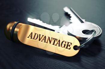Keys and Golden Keyring with the Word Advantage over Black Wooden Table with Blur Effect. Toned Image.