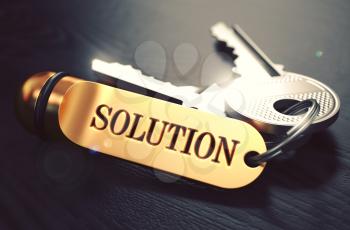 Keys to Solution - Concept on Golden Keychain over Black Wooden Background. Closeup View, Selective Focus, 3D Render. Toned Image.