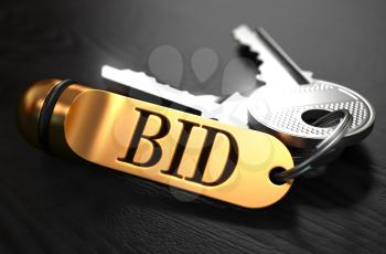 Keys with Word  Bid on Golden Label over Black Wooden Background. Closeup View, Selective Focus, 3D Render.