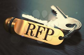 Keys and Golden Keyring with the Word RFP - Request for Proposal - over Black Wooden Table with Blur Effect. Toned Image.
