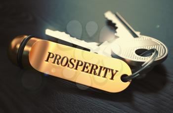 Keys with Word Prosperity on Golden Label over Black Wooden Background. Closeup View, Selective Focus, 3D Render. Toned Image.