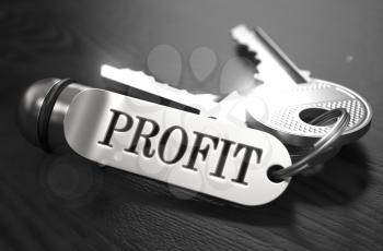 Keys to Profit - Concept on Golden Keychain over Black Wooden Background. Closeup View, Selective Focus, 3D Render. Black and White Image.