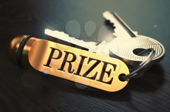 Prize - Bunch of Keys with Text on Golden Keychain. Black Wooden Background. Closeup View with Selective Focus. 3D Illustration. Toned Image.