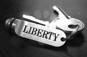 Liberty Concept. Keys with Keyring on Black Wooden Table. Closeup View, Selective Focus, 3D Render. Black and White Image.