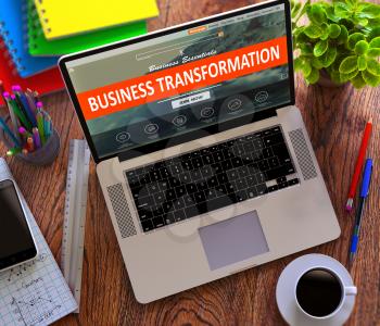 Business Transformation Concept. Modern Laptop and Different Office Supply on Wooden Desktop background.