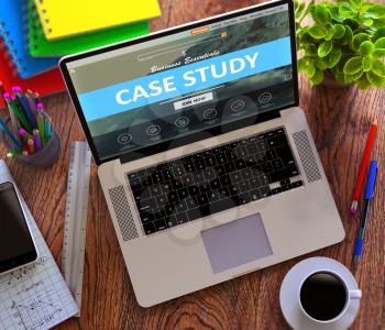 Case Study Concept. Modern Laptop and Different Office Supply on Wooden Desktop background.