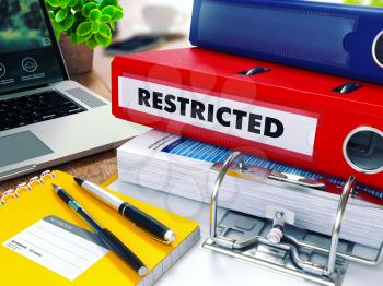 Restricted - Red Ring Binder on Office Desktop with Office Supplies and Modern Laptop. Business Concept on Blurred Background. Toned Illustration.