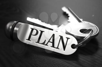 Plan Concept. Keys with Keyring on Black Wooden Table. Closeup View, Selective Focus, 3D Render. Black and White Image.