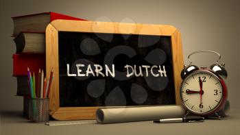 Learn Dutch Concept Hand Drawn on Chalkboard. Blurred Background. Toned Image.