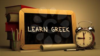 Hand Drawn Learn Greek Concept  on Chalkboard. Blurred Background. Toned Image.