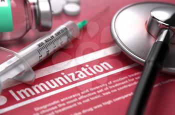 Immunization - Medical Concept on Red Background with Blurred Text and Composition of Pills, Syringe and Stethoscope.