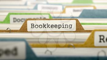 File Folder Labeled as Bookkeeping in Multicolor Archive. Closeup View. Blurred Image.