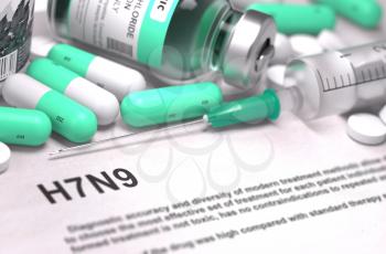 H7N9 - Printed Diagnosis with Mint Green Pills, Injections and Syringe. Medical Concept with Selective Focus.