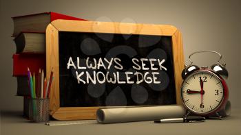 Handwritten Inspirational Quote - Always Seek Knowledge - on Chalkboard. Composition with Chalkboard and Stack of Books, Alarm Clock and Rolls of Paper on Blurred, Toned Image. 