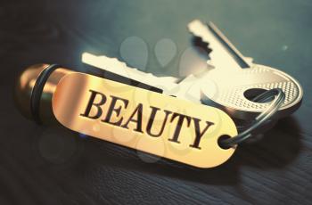 Beauty - Bunch of Keys with Text on Golden Keychain. Black Wooden Background. Closeup View with Selective Focus. 3D Illustration. Toned Image.