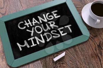 Change Your Mindset. Motivation Quote Hand Drawn on Blue Chalkboard on Wooden Table. Business Background. Top View.