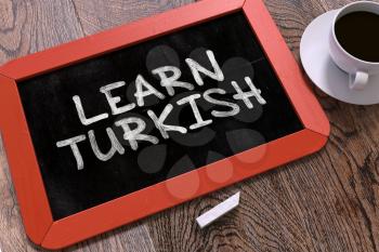 Learn Turkish Handwritten on Red Chalkboard. Business Concept. Composition with Chalkboard and Cup of Coffee. Top View Image. 3d Render.
