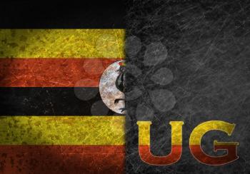 Old rusty metal sign with a flag and country abbreviation - Uganda