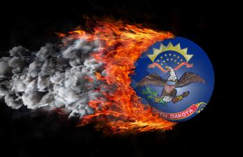 Concept of speed - Flag with a trail of fire and smoke - North Dakota