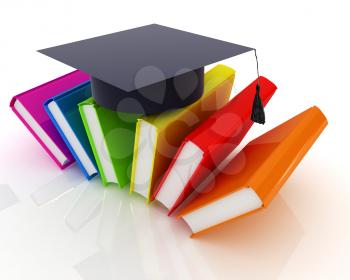Colorful books and graduation hat on a white background