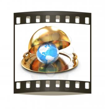 Earth globe on glossy golden salver dish under a golden cover on a white background. The film strip