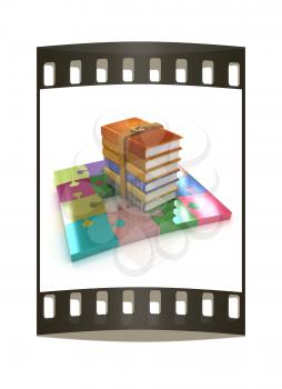 Puzzle and books on a white background. The film strip