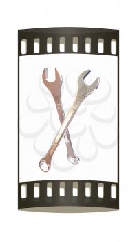 Crossed wrenches on a white background. The film strip