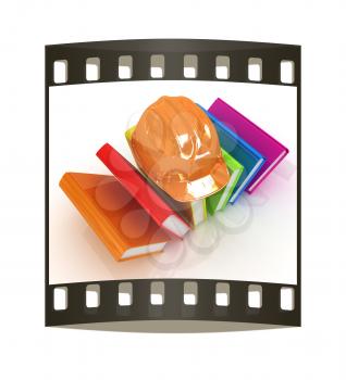 Colorful books and hard hat on a white background. The film strip