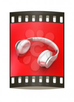 White headphones isolated on a red background. The film strip