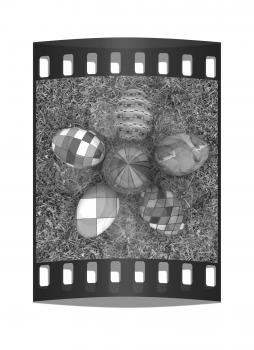 Flower of Easter eggs on the grass. The film strip with place for your text
