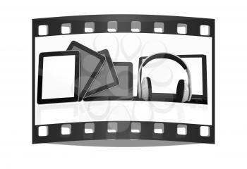 headphones on the  laptop and  tablet pc on a white background. The film strip