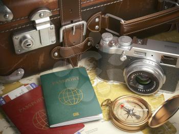 Travel or turism background concept.  Old  suitcase,  passports with boarding pass, vintage camera, campass on the  map. 3d illustration