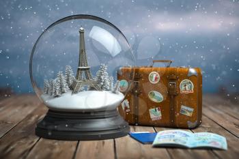 Eiffel tower in the snow globe, vintage suitcase and passports with visa stamp. Travel or trip to Paris and France in winter for celebrate Christmas. 3d illustration