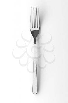 Silver spoon on a table. Fine cutlery on white background. Single fork on a table. Silverware with shadow. 3D illustration.