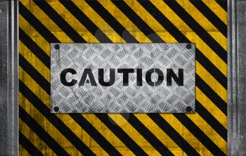 Caution label metal panel on black and yellow striped pattern of industrial concrete wall