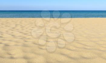 Closeup of sand on tropical sandy beach under summer sunlight and clear blue sky and calm sea in bokeh, shallow depth of field, nature landscape 3D illustration