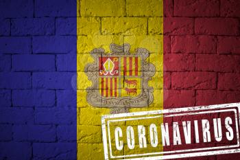 Flag of the Andorra with original proportions. stamped of Coronavirus. brick wall texture. Corona virus concept. On the verge of a COVID-19 or 2019-nCoV Pandemic.
