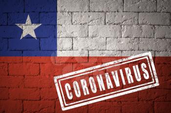 Flag of the Chile on brick wall texture. stamped of Coronavirus. Corona virus concept. On the verge of a COVID-19 or 2019-nCoV Pandemic. Novel Chinese Coronavirus outbreak