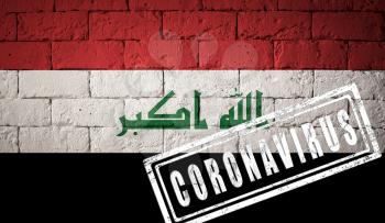 Flag of the Iraq with original proportions. stamped of Coronavirus. brick wall texture. Corona virus concept. On the verge of a COVID-19 or 2019-nCoV Pandemic.