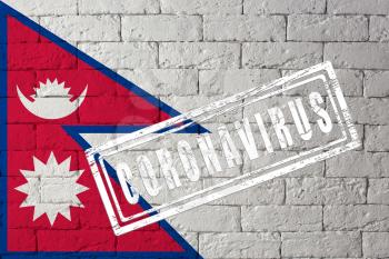 Flag of the Nepal with original proportions. stamped of Coronavirus. brick wall texture. Corona virus concept. On the verge of a COVID-19 or 2019-nCoV Pandemic.