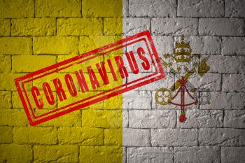 Flag of the Vatican City on brick wall texture. stamped of Coronavirus. Corona virus concept. On the verge of a COVID-19 or 2019-nCoV Pandemic. Novel Chinese Coronavirus outbreak