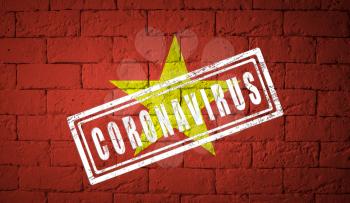 Flag of the Vietnam with original proportions. stamped of Coronavirus. brick wall texture. Corona virus concept. On the verge of a COVID-19 or 2019-nCoV Pandemic.