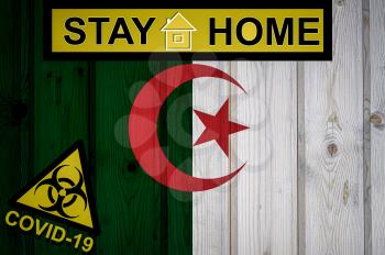 Flag of the Algeria in original proportions. Quarantine and isolation - Stay at home. flag with biohazard symbol and inscription COVID-19.